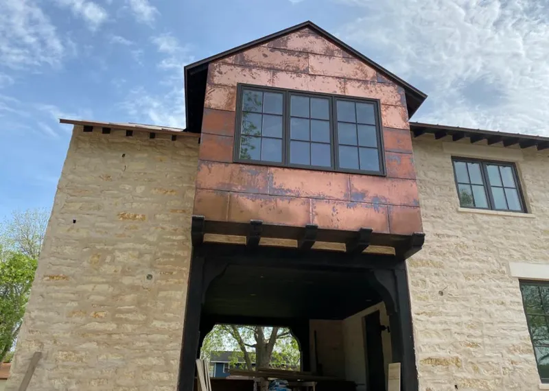 Copper metal panel facade on a stone building for Skylight Installation in Ormond Beach