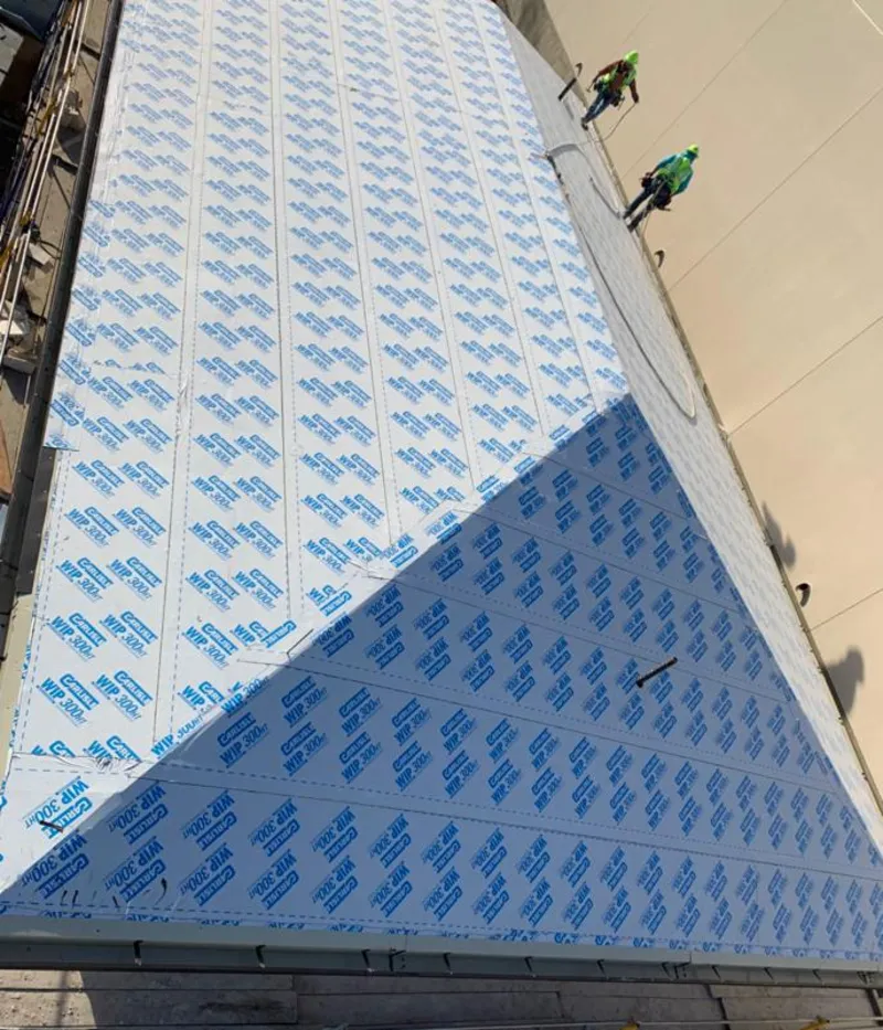 Professional roofers installing underlayment on a metal roof in Ormond Beach